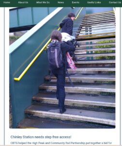 Two people trying to get a pushchair up Chinley station steps